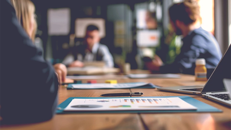 Business meeting focused on documents and graphics.