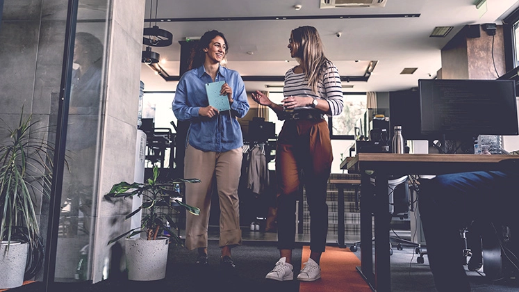Team members in an open, modern office environment demonstrating collaboration.